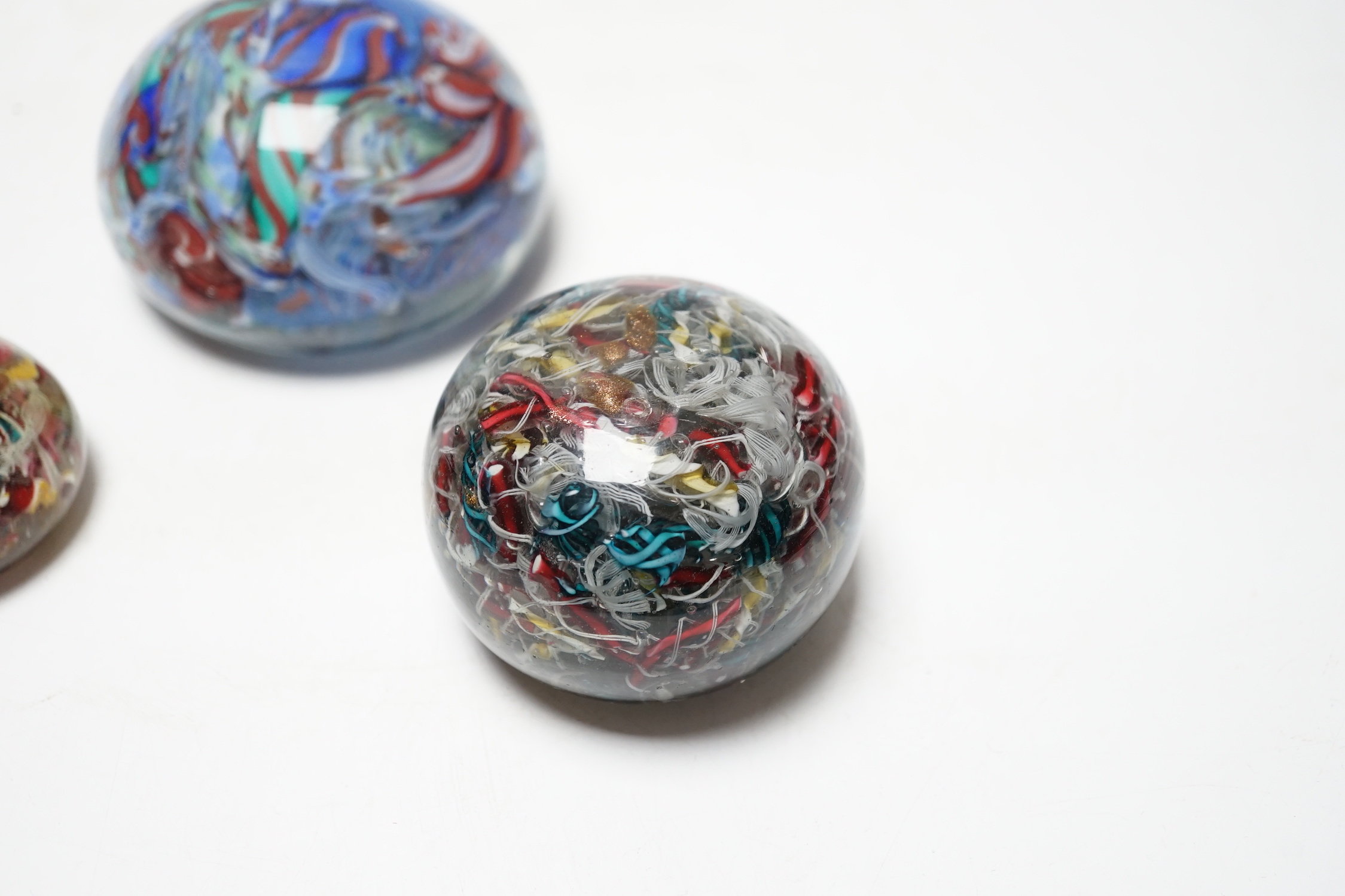 Three 19th century Venetian scrambled glass paperweights, largest 8.5cm